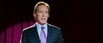 Movie still from “Teenage Mutant Ninja Turtles” (2014), directed by Jonathan Liebesman – A person wearing a suit and tie; Close Up shot, Over the shoulder angle