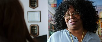 Movie still from “Teenage Mutant Ninja Turtles” (2014), directed by Jonathan Liebesman – A person wearing glasses and smiling; Close Up shot, Over the shoulder angle