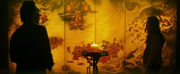 Movie still from “Teenage Mutant Ninja Turtles” (2014), directed by Jonathan Liebesman – A lit candle sitting on top of a table; Wide shot, High angle