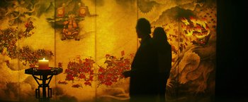 Movie still from “Teenage Mutant Ninja Turtles” (2014), directed by Jonathan Liebesman – Two people are standing in front of a painting; Medium shot, Low angle
