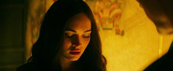 Movie still from “Teenage Mutant Ninja Turtles” (2014), directed by Jonathan Liebesman – A woman with her eyes closed looking down at the ground; Close Up shot, Low angle