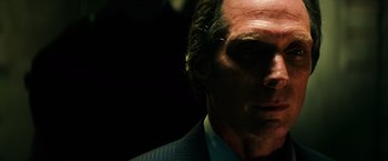 Movie still from “Teenage Mutant Ninja Turtles” (2014), directed by Jonathan Liebesman – A person wearing a suit and tie; Close Up shot, Low angle