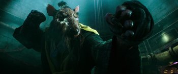 Movie still from “Teenage Mutant Ninja Turtles” (2014), directed by Jonathan Liebesman – A dog with a yellow collar and a green jacket; Close Up shot, High angle