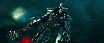 Movie still from “Teenage Mutant Ninja Turtles” (2014), directed by Jonathan Liebesman – A metal statue of a man in a suit of armor; Medium shot, Low angle