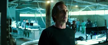 Movie still from “Teenage Mutant Ninja Turtles” (2014), directed by Jonathan Liebesman – A man standing in front of a building with lights on; Close Up shot, Low angle