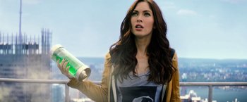 Movie still from “Teenage Mutant Ninja Turtles” (2014), directed by Jonathan Liebesman – A beautiful woman holding a bottle and looking up; Close Up shot, Low angle