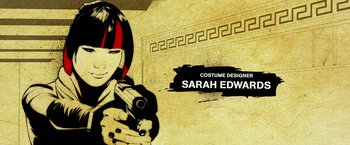 Movie still from “Teenage Mutant Ninja Turtles” (2014), directed by Jonathan Liebesman – A woman holding a gun in front of a wall; Extreme Close Up shot, High angle