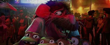 Movie still from “Teenage Mutant Ninja Turtles: Mutant Mayhem” (2023), directed by Jeff Rowe – A cartoon of a red mouse surrounded by a group of people; Extreme Close Up shot, Low angle