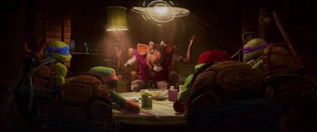 Movie still from “Teenage Mutant Ninja Turtles: Mutant Mayhem” (2023), directed by Jeff Rowe – A group of people sitting around a table; Medium shot, Over the shoulder angle