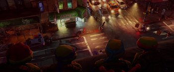 Movie still from “Teenage Mutant Ninja Turtles: Mutant Mayhem” (2023), directed by Jeff Rowe – An overhead view of an intersection at night; Extreme Wide shot, Overhead angle