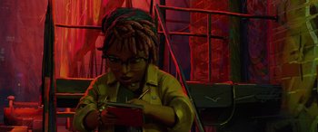 Movie still from “Teenage Mutant Ninja Turtles: Mutant Mayhem” (2023), directed by Jeff Rowe – A woman with dreads looking at her cell phone; Medium shot, High angle