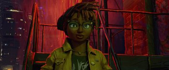Movie still from “Teenage Mutant Ninja Turtles: Mutant Mayhem” (2023), directed by Jeff Rowe – A person with dreads and glasses in front of a red background; Close Up shot, Low angle