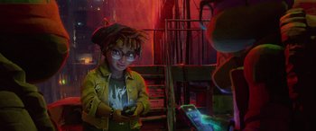 Movie still from “Teenage Mutant Ninja Turtles: Mutant Mayhem” (2023), directed by Jeff Rowe – A young man holding a cell phone in his hands; Medium shot, Over the shoulder angle