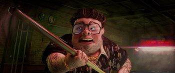 Movie still from “Teenage Mutant Ninja Turtles: Mutant Mayhem” (2023), directed by Jeff Rowe – An image of a man holding a baseball bat; Close Up shot, Low angle