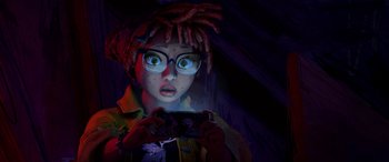 Movie still from “Teenage Mutant Ninja Turtles: Mutant Mayhem” (2023), directed by Jeff Rowe – A woman with a video game controller in her hands; Close Up shot, Overhead angle