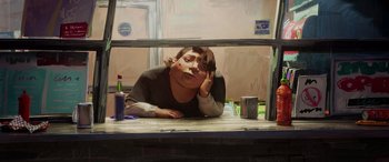 Movie still from “Teenage Mutant Ninja Turtles: Mutant Mayhem” (2023), directed by Jeff Rowe – A woman sitting at a table with her head resting on her hand; Medium shot, Low angle