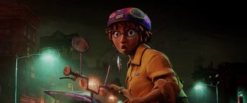 Movie still from “Teenage Mutant Ninja Turtles: Mutant Mayhem” (2023), directed by Jeff Rowe – A person with a helmet on riding on a motorcycle; Medium shot, Low angle