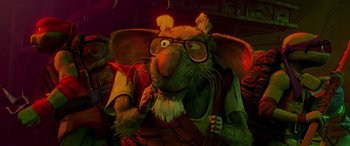 Movie still from “Teenage Mutant Ninja Turtles: Mutant Mayhem” (2023), directed by Jeff Rowe – A stuffed animal wearing glasses and holding a microphone; Close Up shot, Low angle