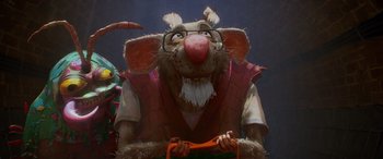 Movie still from “Teenage Mutant Ninja Turtles: Mutant Mayhem” (2023), directed by Jeff Rowe – An animated rat with glasses and a red vest holding an orange carrot; Medium shot, Low angle