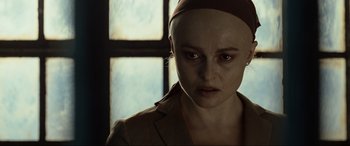 Movie still from “Terminator Salvation” (2009), directed by McG – A woman with a bald head looking at the camera; Close Up shot, Over the shoulder angle