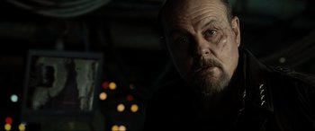 Movie still from “Terminator Salvation” (2009), directed by McG – An older man with a beard is looking at the camera; Close Up shot, Low angle