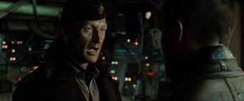 Movie still from “Terminator Salvation” (2009), directed by McG – A person wearing a uniform; Close Up shot, Over the shoulder angle