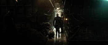 Movie still from “Terminator Salvation” (2009), directed by McG – Two men are walking down a dark hallway; Wide shot, High angle