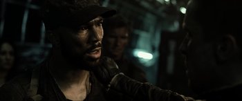 Movie still from “Terminator Salvation” (2009), directed by McG – A person wearing a hat and gloves; Close Up shot, Over the shoulder angle