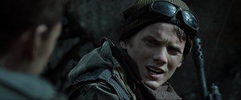 Movie still from “Terminator Salvation” (2009), directed by McG – A person wearing a jacket and hat; Close Up shot, Over the shoulder angle