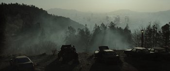 Movie still from “Terminator Salvation” (2009), directed by McG – A couple of cars parked on top of a grass covered hill; Extreme Wide shot, Low angle