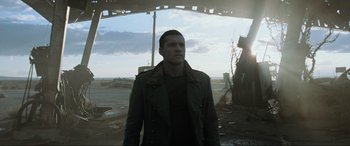 Movie still from “Terminator Salvation” (2009), directed by McG – A man standing in the middle of an abandoned area; Medium shot, Low angle