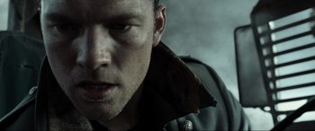 Movie still from “Terminator Salvation” (2009), directed by McG – A man's face in a military jacket; Close Up shot, Low angle