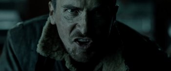 Movie still from “Terminator Salvation” (2009), directed by McG – A man's face in a dark room; Close Up shot, Low angle