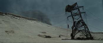 Movie still from “Terminator Salvation” (2009), directed by McG – A person is hanging from a rope in the desert; Extreme Wide shot, Low angle
