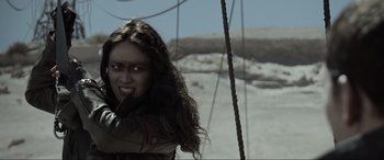 Movie still from “Terminator Salvation” (2009), directed by McG – A woman with long dark hair is smiling for the camera; Close Up shot, Over the shoulder angle