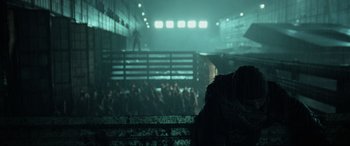 Movie still from “Terminator Salvation” (2009), directed by McG – A crowd of people standing in a dark room; Wide shot, Over the shoulder angle