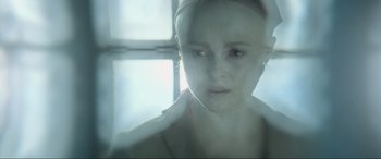 Movie still from “Terminator Salvation” (2009), directed by McG – A woman with a white head band is looking at the camera; Close Up shot, Over the shoulder angle