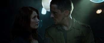 Movie still from “Terminator Salvation” (2009), directed by McG – A man and a woman standing next to each other in the dark; Close Up shot, Low angle