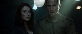 Movie still from “Terminator Salvation” (2009), directed by McG – A man and a woman standing next to each other in the dark; Close Up shot, Over the shoulder angle