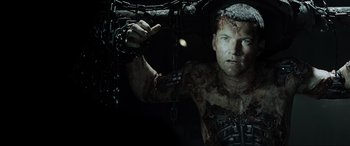 Movie still from “Terminator Salvation” (2009), directed by McG – A man in chains with blood all over his body; Close Up shot, High angle