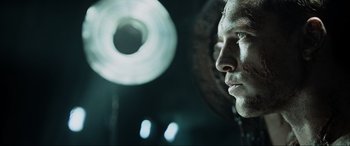 Movie still from “Terminator Salvation” (2009), directed by McG – A man's face in front of a light fixture; Close Up shot, Over the shoulder angle