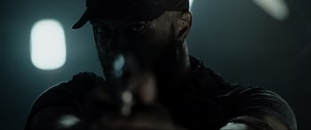 Movie still from “Terminator Salvation” (2009), directed by McG – A person holding a gun pointed at the camera; Extreme Close Up shot, Low angle