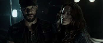 Movie still from “Terminator Salvation” (2009), directed by McG – A man and a woman standing next to each other in the dark; Close Up shot, Low angle