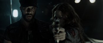 Movie still from “Terminator Salvation” (2009), directed by McG – A man and a woman holding a gun in a dark room; Close Up shot, Over the shoulder angle