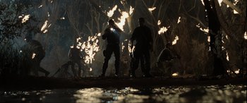 Movie still from “Terminator Salvation” (2009), directed by McG – A group of men standing next to each other in the dark; Wide shot, Low angle