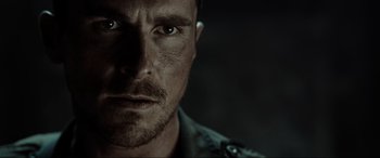 Movie still from “Terminator Salvation” (2009), directed by McG – A man's face in a dark room; Close Up shot, Over the shoulder angle