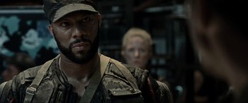 Movie still from “Terminator Salvation” (2009), directed by McG – A person wearing a hat and a jacket; Close Up shot, Over the shoulder angle