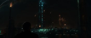 Movie still from “Terminator Salvation” (2009), directed by McG – A man standing in front of a tall building at night; Extreme Wide shot, Low angle