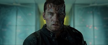 Movie still from “Terminator Salvation” (2009), directed by McG – A person with a face covered in blood; Close Up shot, Over the shoulder angle