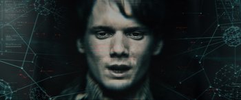 Movie still from “Terminator Salvation” (2009), directed by McG – A man with long black hair is looking at the camera; Extreme Close Up shot, Overhead angle